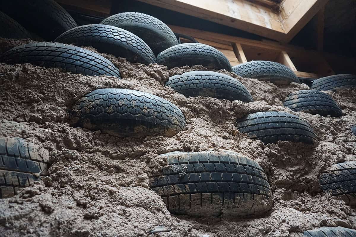 Rammed Earth Tire Wall that is the foundation for an Earthship.